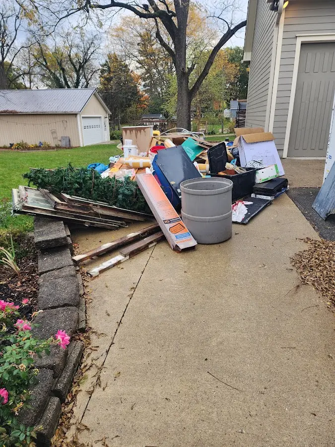 Dumpster being loaded with debris for 12 Yard Dumpster Rental in Sun City West